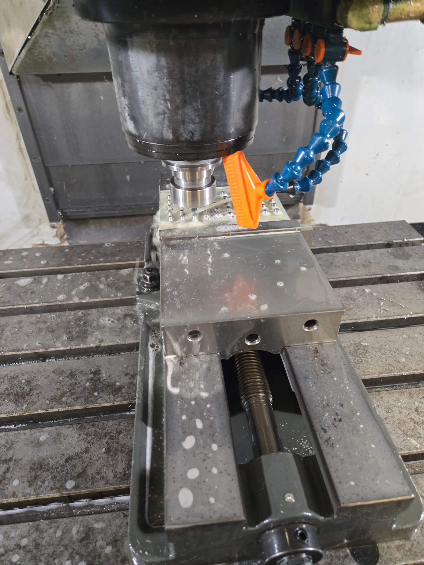 CNC mill cutting an aluminium part held in a vise