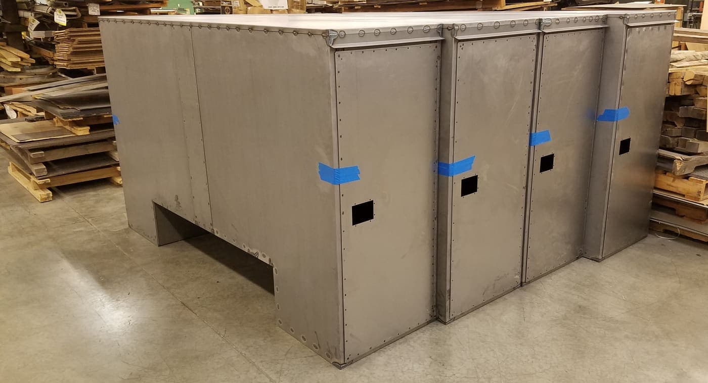 Large stainless steel enclosure shell with formed panels and cut-outs
