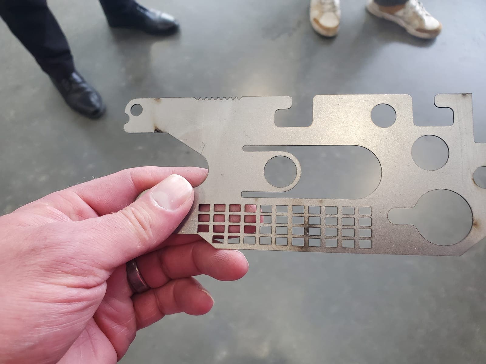 The finished laser-cut part in hand at the SMF shop